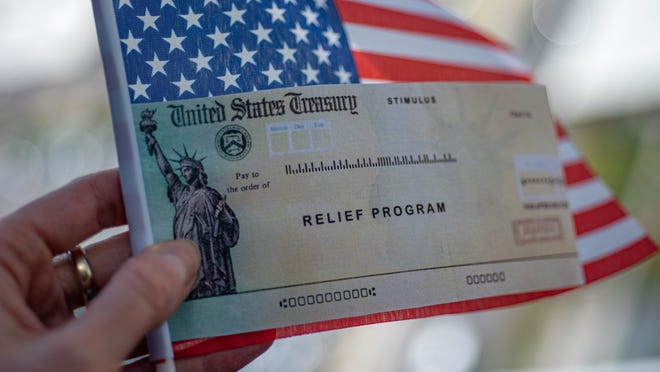 A relief check being held with an American flag.