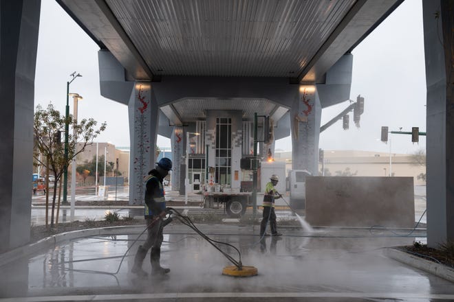 Crews steam clean the pavement at the Thelda Williams Transit Center on Jan. 23, 2024, in Phoenix.