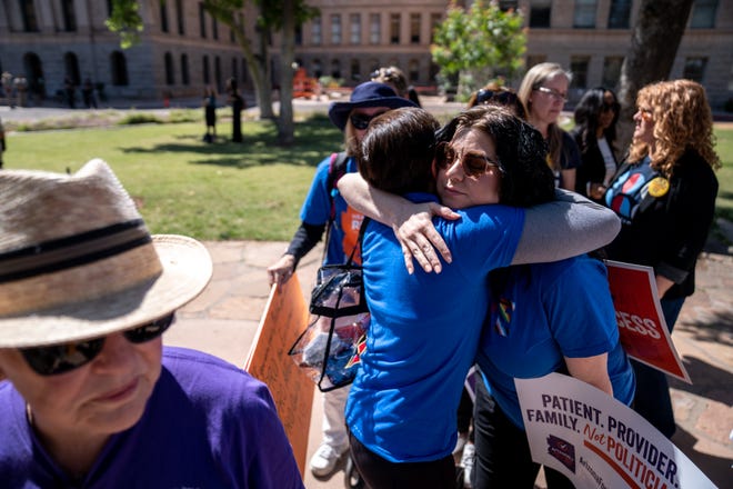 Abortion rights activists Marion Weich (left) hugs Carolyn LaMantia during a news conference addressing the Arizona Supreme Court's ruling to uphold a 160-year-old near-total abortion ban at the Arizona state Capitol in Phoenix on April 9, 2024.