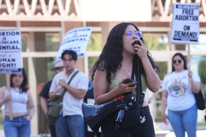 Lexsiri Coronada leads the chants of protesters gathered at the Capitol in downtown Phoenix on April 11, 2024, to protest the recent Arizona Supreme Court ruling upholding an 1864 abortion law, banning the procedure in most cases.