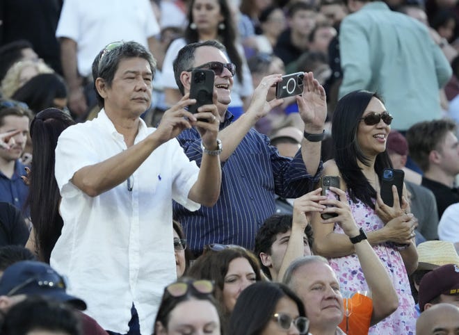 Friends and family take pictures during Arizona State University's commencement ceremony in Tempe.