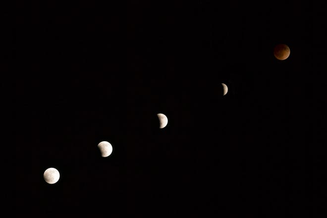 A "blood moon" lunar eclipse is shown in this multiple exposure April 14-15, 2014. A lunar eclipse occurs when the sun, moon, and Earth align so that Earth's shadow falls across the moon's surface.