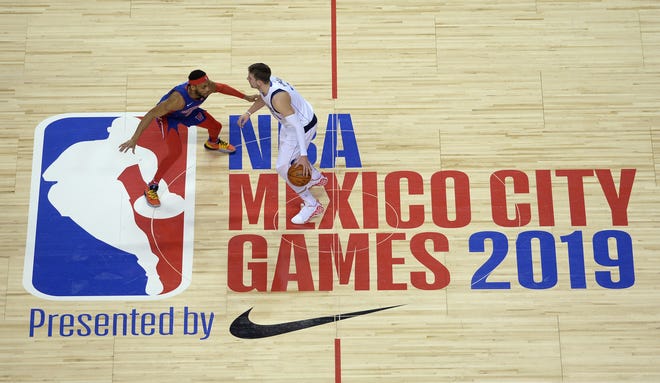 Dallas Mavericks forward Luka Doncic dribbles while defended by Detroit Pistons guard Bruce Brown in the first half in Mexico City, Dec. 12, 2019.