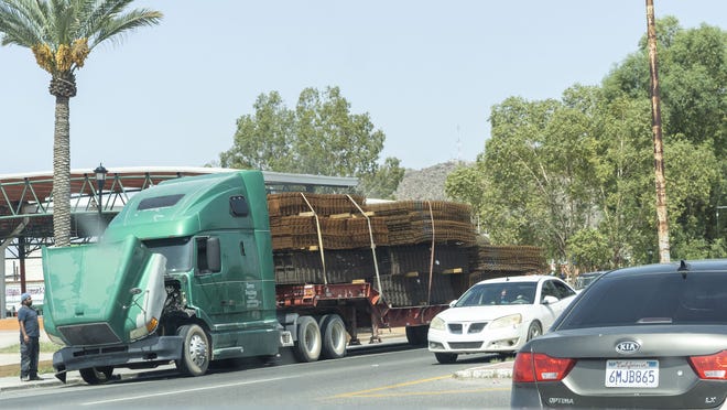 A truck carrying metal and other construction materials for border construction.