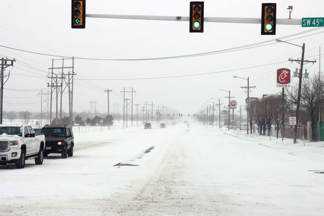 Motorists navigate the area of SW 45th Avenue and Coulter Street during Sunday's winter weather event.