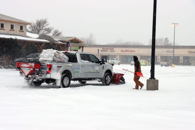 Crews, like Amarillo Land Services work on parking lots moving snow during an arctic blast on Valentine's Day.