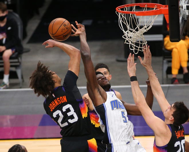 Phoenix Suns forward Cameron Johnson (23) blocks a shot by Orlando Magic center Mo Bamba (5) during the first quarter Feb. 14, 2021.