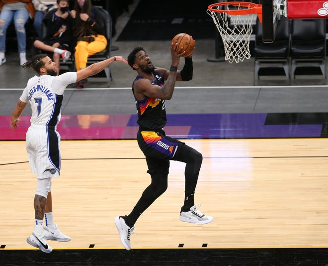 Phoenix Suns center Deandre Ayton (22) lays the ball in past Orlando Magic guard Michael Carter-Williams (7) during the third quarter Feb. 14, 2021.