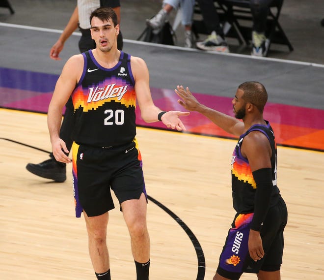 Phoenix Suns forward Dario Saric (20) and guard Chris Paul (3) slap hands after a basket against the Orlando Magic during the second quarter Feb. 14, 2021.