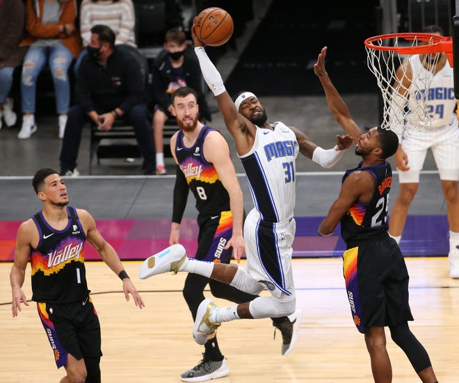 Orlando Magic guard Terrence Ross (31) slams two against Phoenix Suns forward Mikal Bridges (25) during the second quarter Feb. 14, 2021.