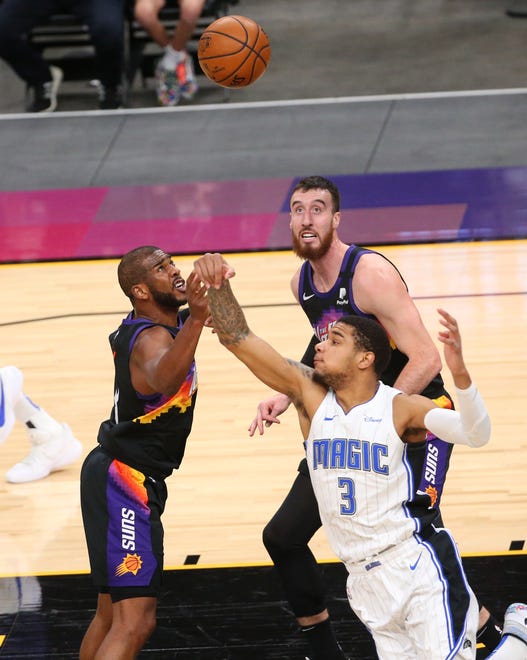 Phoenix Suns guard Chris Paul (3) and Orlando Magic forward Chuma Okeke (3) battle for a rebound during the first quarter Feb. 14, 2021.