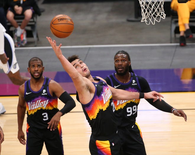 Phoenix Suns forward Dario Saric (20) grabs a rebound against the Orlando Magic during the second quarter Feb. 14, 2021.