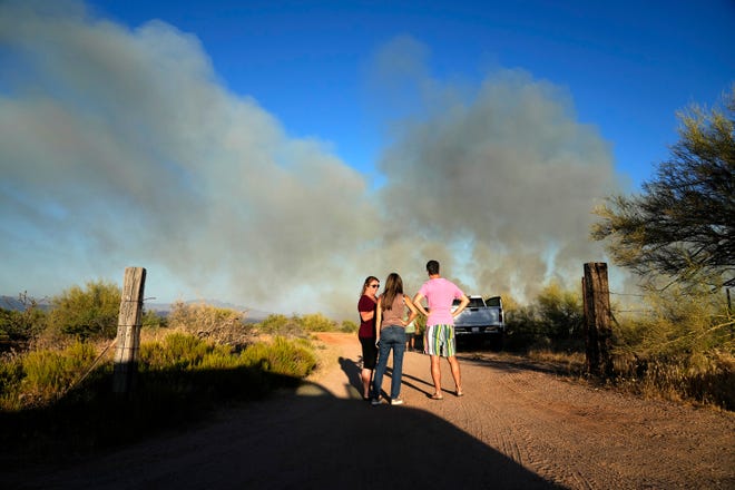 Residents watch the Diamond Fire burn south of Rio Verde Drive in northeast of Scottsdale on June 27, 2023.